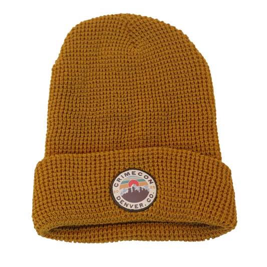 Brown knit beanie with a logo patch on a white background