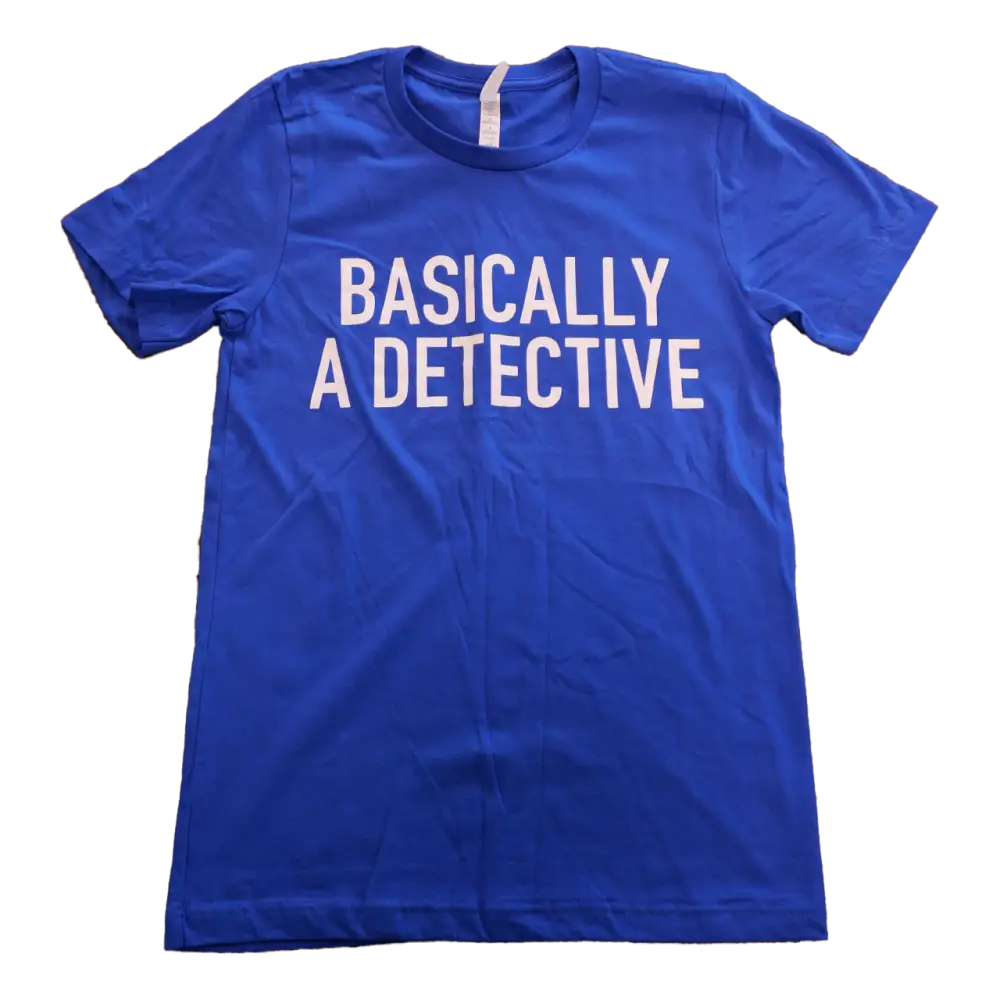 Blue t-shirt with white text reading ’BASICALLY A DETECTIVE’.