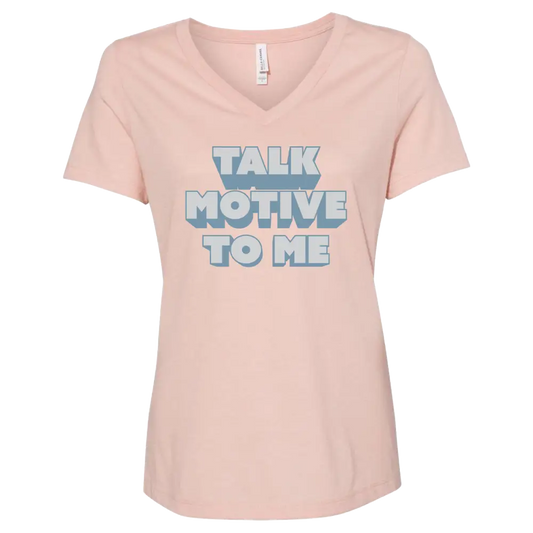 Pink v-neck t-shirt with ’TALK MOTIVE TO ME’ printed in blue and white text.