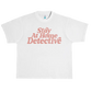 White t-shirt with pink text reading ’Stay At Home Detective’.